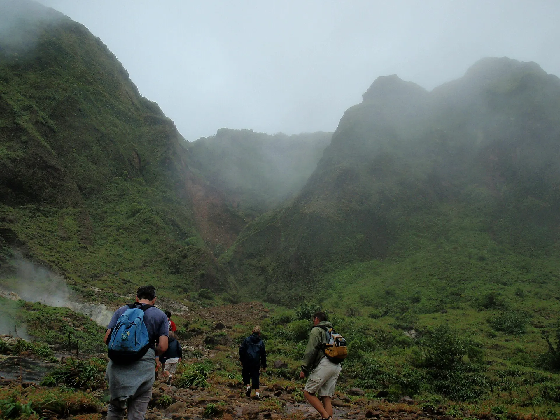 Hikers crossing the steaming Valley of Desolation on the Boiling Lake trail
