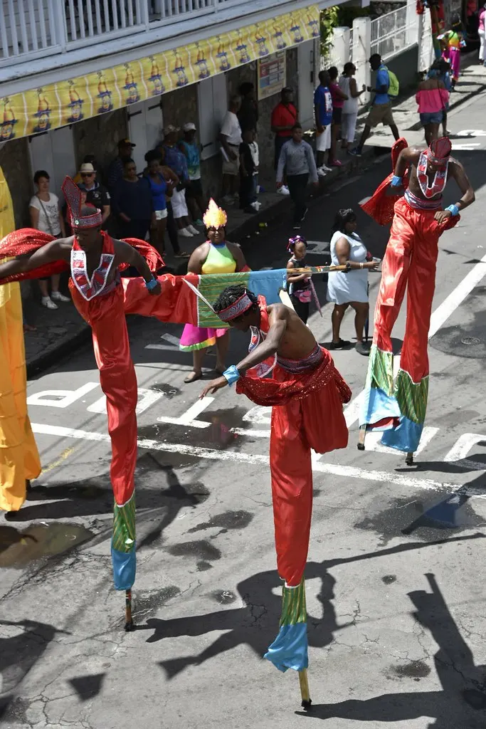 Stilt walkers in red and gold at carnival